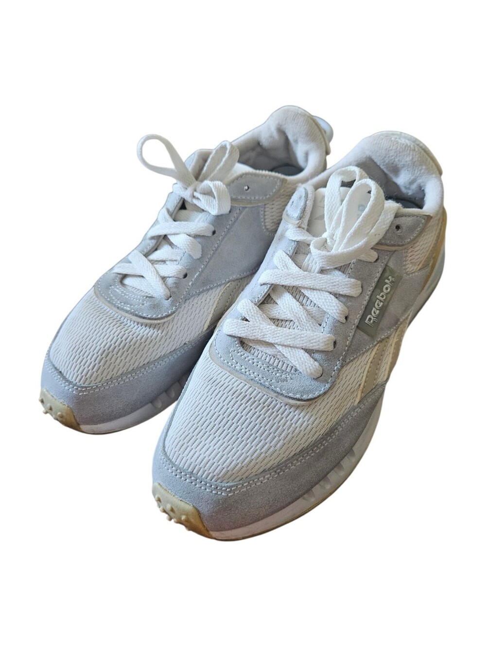 Reebok Classic Legacy sneakers feature a white mesh upper with gray suede overla